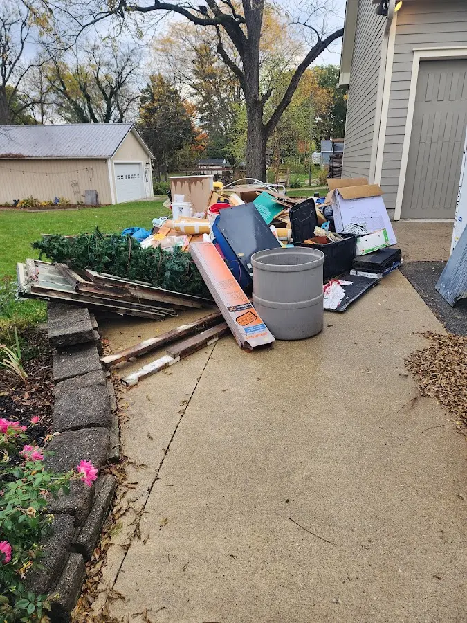 Dumpster being loaded with debris for 12 Yard Dumpster Rental in Oxon Hill